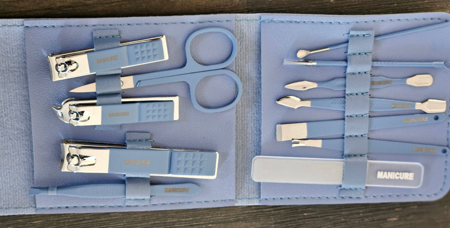 Manicure set with various tools in a blue case on a wooden surface