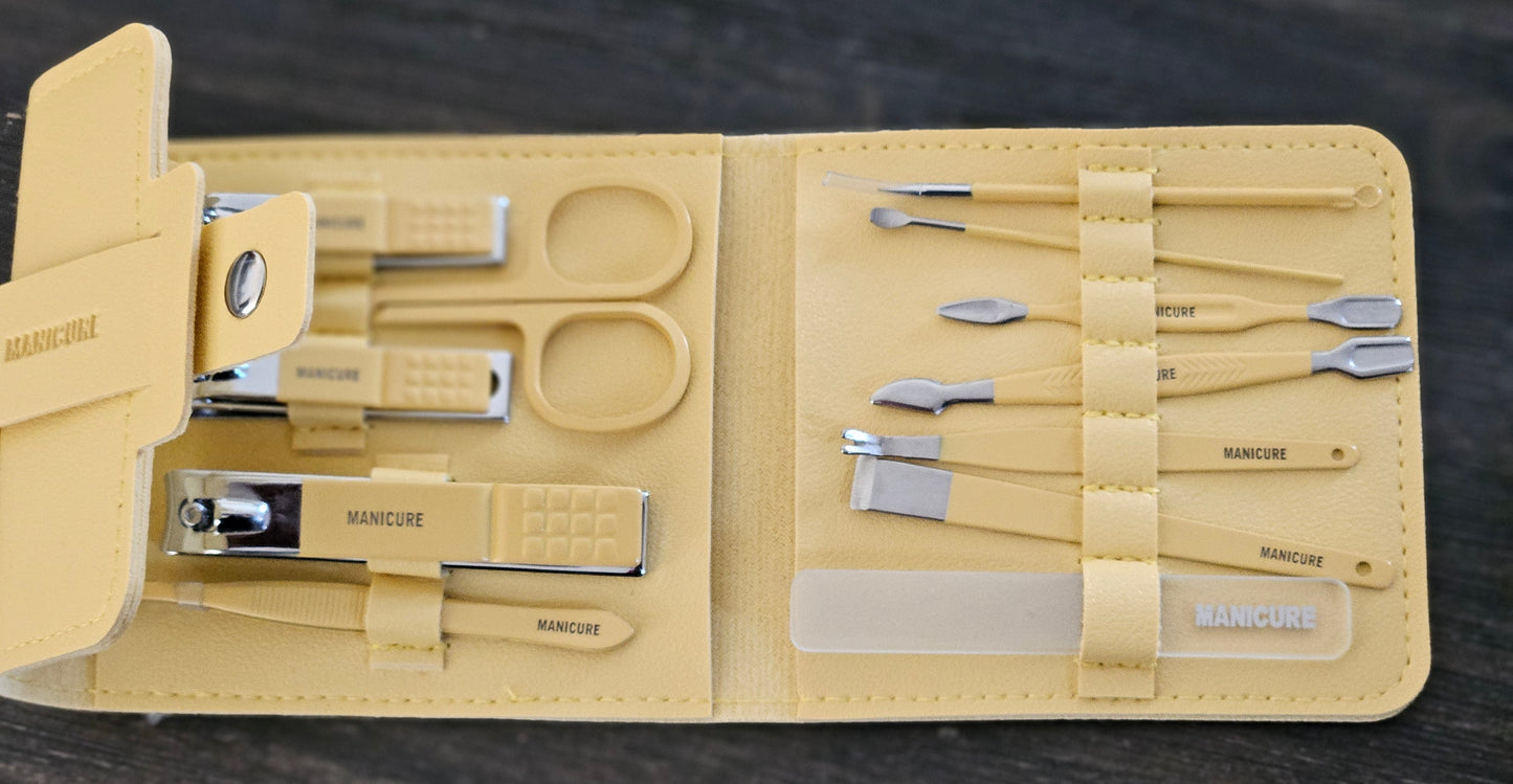 Manicure set with tools in a beige case on a dark background