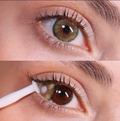 Close-up of a person's eye with a green two tone contact lens being inserted.