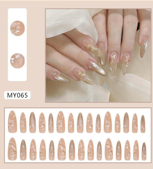Nail art design sheet with beige nail shapes and a hand model wearing the nails.